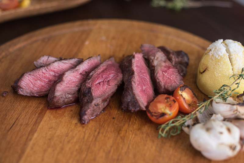 grilled beef steak with herbs and vegetables